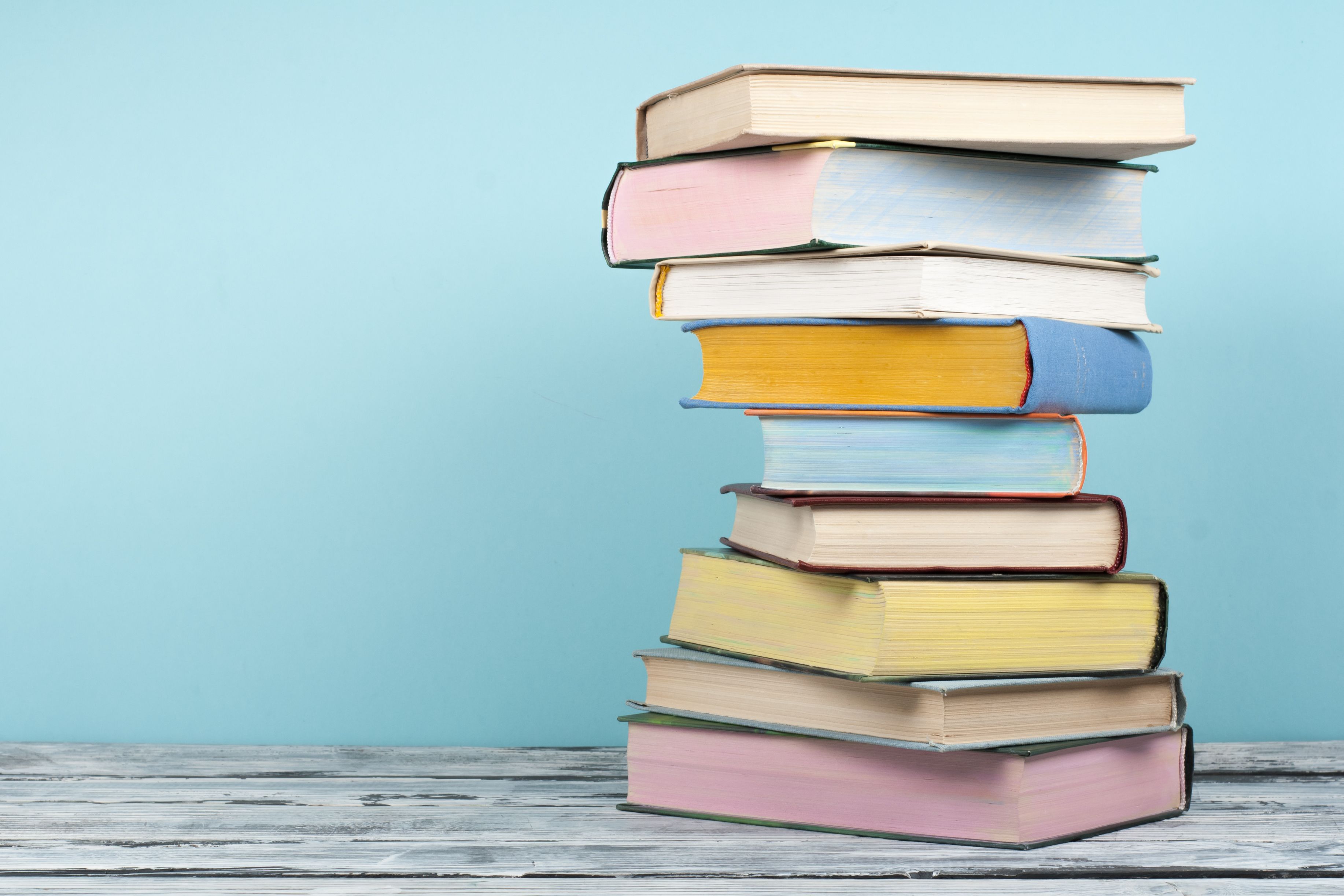 Open book, stacking, hardback books on wooden table and background ...